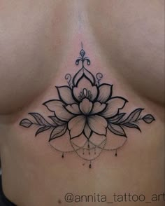 a woman's stomach with a flower tattoo on it