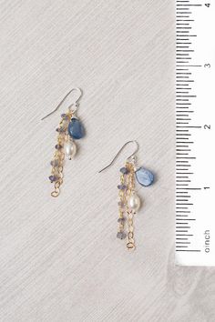 Experience the beauty and craftsmanship of the Seaside Collection with these gorgeous handmade earrings. Mixed Metal (lead and nickel free) Kyanite, Iolite, Pearl 2", with sterling silver ear wires We hand select our natural materials, thus there may be slight variations in color and/or size that will not detract from the overall aesthetic Our unique handcrafted designer jewelry for women is made in America, with each design created individually in our personal design studio in Floyd VA USA Earring Handmade Ideas, Jewelry Inspo Earrings, Boujee Jewelry, Bridgerton Diy, Diy Beaded Jewelry, Floyd Va, Kyanite Jewelry, Silver Jewelry Diy, Pretty Jewelry Necklaces