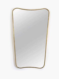 a gold framed mirror hanging on the wall with a white back ground and yellow trim around it