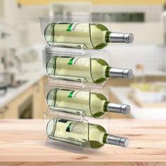 four bottles of wine are stacked up on a counter