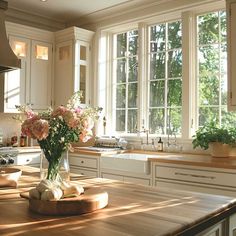 a kitchen counter with flowers in a vase on it