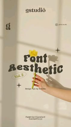 a person holding a flower in front of a sign that says font aesthetic vol 2