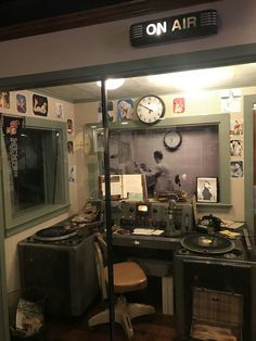 the inside of an old fashioned recording studio with record players and clocks on the wall