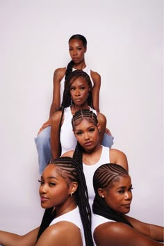 four women with braids on their heads are posing for the camera in front of a white background