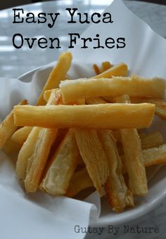 a white plate topped with french fries on top of a table next to a napkin