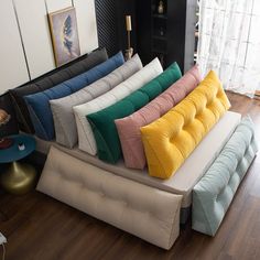 a bunch of pillows sitting on top of a couch