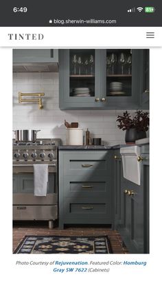 a kitchen with gray cabinets and white walls