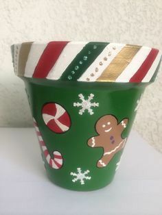 a green cup decorated with gingerbreads and candy canes