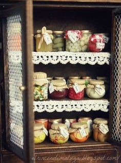 an old wooden cabinet filled with lots of jars