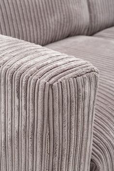 an upholstered couch with pleated cushions