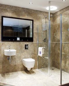 a bathroom with a toilet, sink and shower stall in it's own area