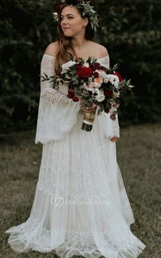 a woman in a white dress holding flowers and wearing a flower crown on her head