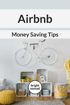 a bike is hanging on the wall above a rug and some bins with books