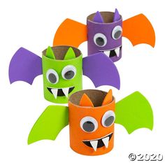 three paper cups decorated to look like bats