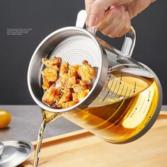 a person pours honey into a bowl with some bread crumbs in it