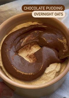 a bowl filled with chocolate pudding on top of a table