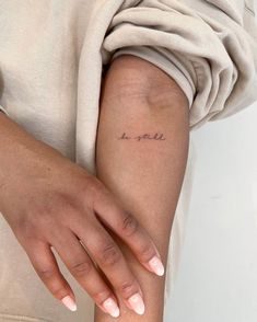 a woman's arm with the word love written in cursive writing on it