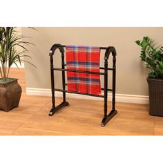 a towel rack with a red and blue plaid blanket on it