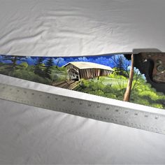 there is a large ruler with a painting on it that has been cut in half