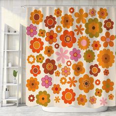 an orange and pink flower shower curtain hanging on a white wall next to a ladder