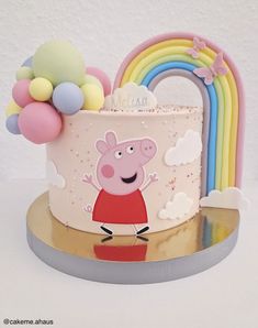 a peppa pig birthday cake with balloons on top