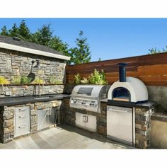 an outdoor kitchen with stone walls and grill