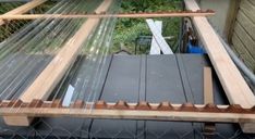 the inside of a chicken coop with wood and netting on it's sides, as seen from above