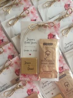 wedding favors are laid out next to each other on the table with tags and ribbons