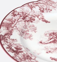 a plate with an image of a woman in the woods on it's side