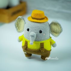 a crocheted elephant wearing a yellow hat