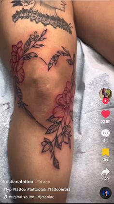 a woman's arm with tattoos on it and flowers in the middle of her leg