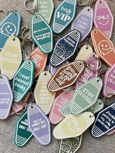 many different colored key chains with words on them