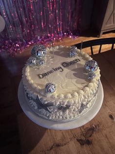 a white cake sitting on top of a wooden table