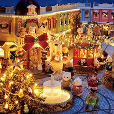 a christmas display with teddy bears and lights in the center, surrounded by holiday decorations