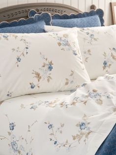 a bed with blue and white flowers on it