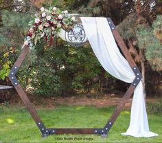 a wedding arch decorated with flowers and greenery