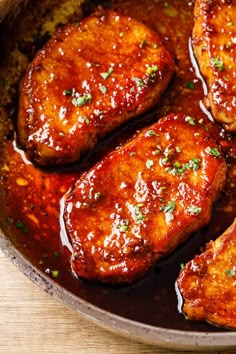 some meat is cooking in a pan on the table