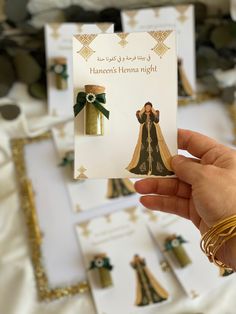 a person holding up a card with some decorations on it