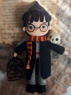 a crocheted harry potter doll holding an owl