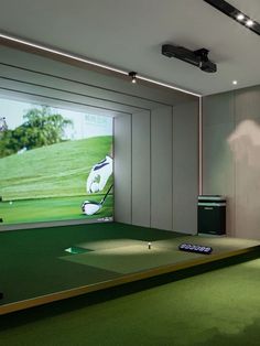 an indoor golf simulator is set up to allow players to play on the green while watching television