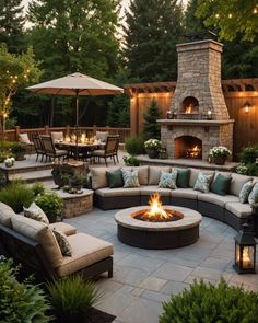 a fire pit in the middle of a patio surrounded by furniture and trees with lights on them