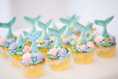 cupcakes decorated with mermaid tails and flowers