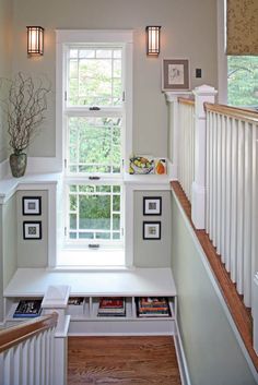 the stairs are lined with books, magazines and vases on top of each other