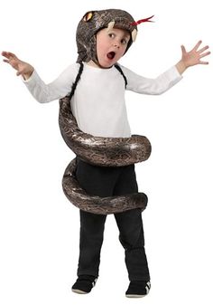 a little boy in a costume with a snake on his back