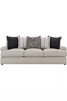 a white couch with black and gray pillows