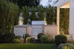 an outdoor kitchen and grill in the evening