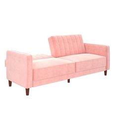 a pink couch sitting on top of a white floor