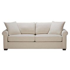 a white couch with two pillows on it