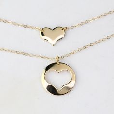 Mother Daughter Necklace Set. 14K gold necklace  Mother's necklace: - 14K gold charm is about 13mm, it is 22 gauge. - 14K gold necklace Daughter's Necklace: - 14K gold heart charm is about 10mm x 8mm, it is 22 gauge. - 14K gold necklace Necklace size chart: average 0 - 12 months 10" average 12 - 24 months 12" average 2-3 years 13" average 4-5 years 14" average 5-10 years 15"-16" 14K gold components Your necklaces will be shipped in a gift box. To see other Mother daughter set click here: https://www.etsy.com/shop/SashJewelry?section_id=12441134&ref=shopsection_leftnav_1 To see more children's jewelry click on the link below. http://www.etsy.com/shop/SashJewelry?section_id=12441132 To see more Sash Jewelry items click on the link below. http://www.etsy.com/shop/SashJewelry Please don't hesi Mother Daughter Jewelry Ideas, 14k Gold Filled Yellow Gold Charm Necklace For Anniversary, Everyday 14k Gold Double Heart Charm Necklace, 14k Gold Double Heart Charm Necklace, Everyday Double Heart 14k Gold Charm Necklace, Yellow Gold Open Heart Jewelry Gift For Mom, 14k Gold Filled Double Heart Jewelry Gift, 14k Gold Filled Open Heart Jewelry For Anniversary, 14k Gold Double Heart Charm Necklace Gift