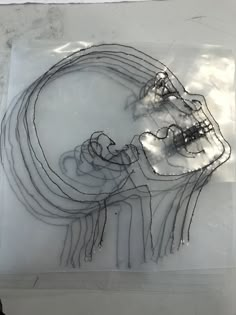 a piece of art that is on top of a sheet of paper with wires attached to it